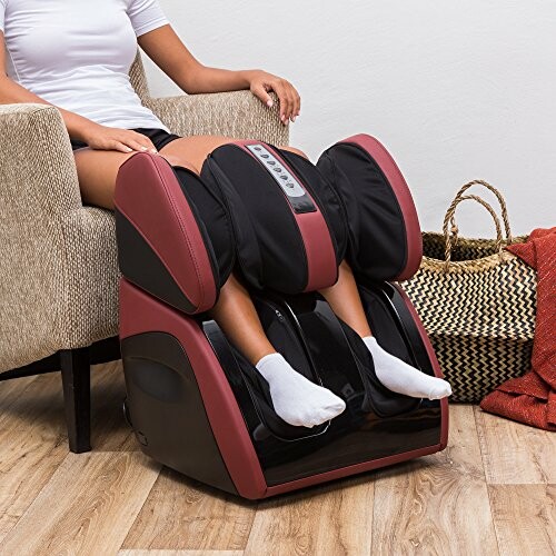 Person using a red and black foot and leg massager.