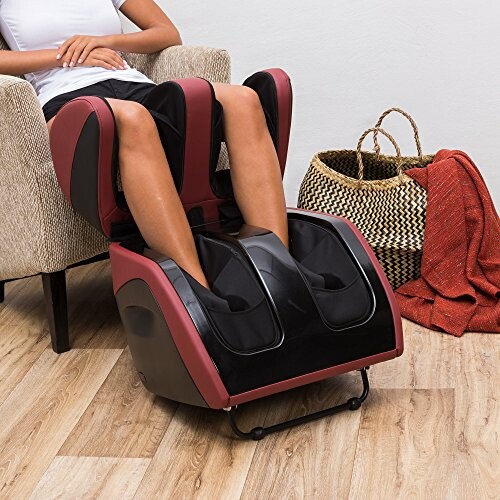 Person using a foot massage chair in a living room setting.
