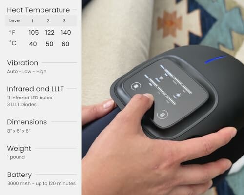 Hand adjusting settings on a handheld massager with heat and infrared options.