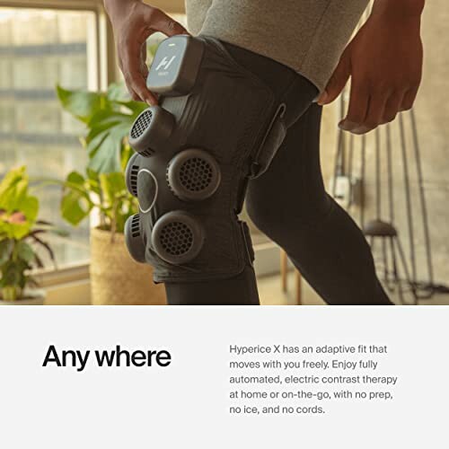 Person wearing a leg compression therapy device indoors.