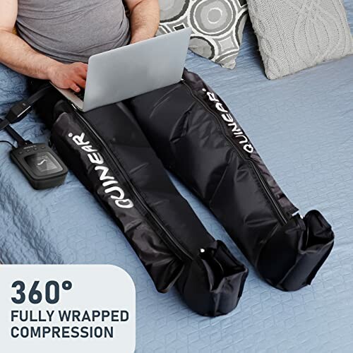 Person using leg compression massager on bed