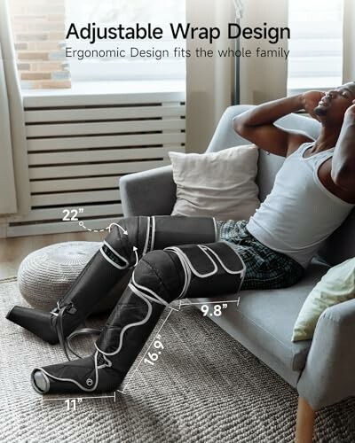 Person using adjustable leg massager on a couch.