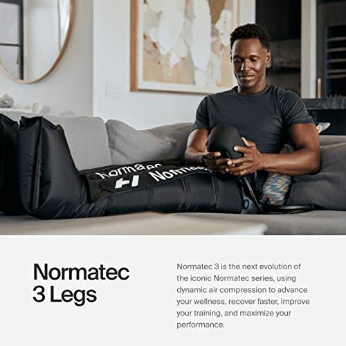 Man using Normatec 3 Legs compression device on a couch.