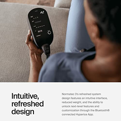 Person holding Normatec 3 device with intuitive design.
