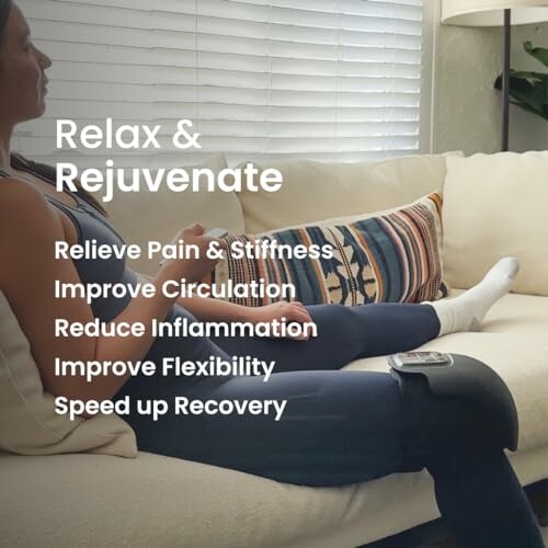 Person using leg therapy device on couch.