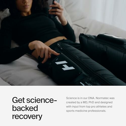 Person using a Normatec recovery device on legs.